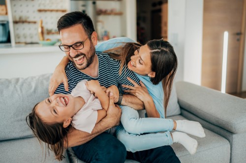 Family hugging on a couch