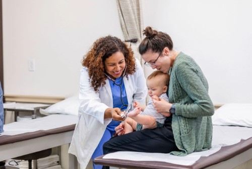 mother holding a baby at the doctor's office