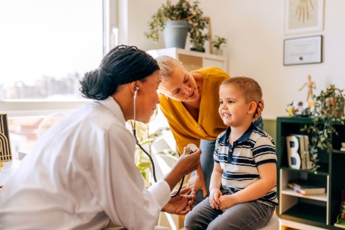 doctor showing a stethoscope to child